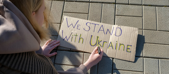 poster with the inscription we stand Ukraine War Ukraine and Russia. The flag of Ukraine and the...