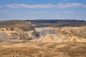 sunny illuminated stone pit scenery in Southern Germany with blue sky and clouds