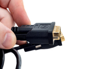 Hands holding a cable to connect to a monitor or TV. VGA cable to adapter