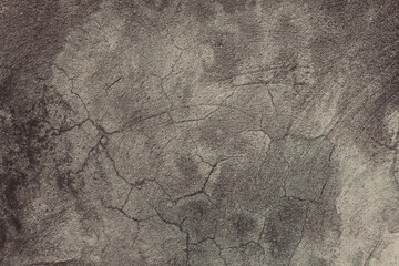 An old cement wall background. A cracked concrete wall texture with damages and scratches.