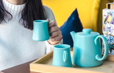 Teapot and two blue cups on the table, top view.