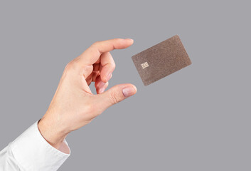 Hand and levitating credit card. Online shopping and cashless payment concept . High quality photo