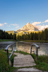 Bridge on Lake Antorno and the three peaks of Lavaredo in the background