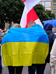 couple with the ukrainian flag at a demonstration against the war in ukraine.