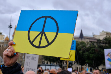 poster of the symbol of peace on the ukrainian flag at a demonstration against the war in ukraine.