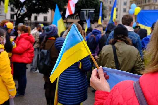 Ukrainian flag at a protest rally against the war in Ukraine. stop war - Powered by Adobe