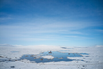 Fototapeta na wymiar Rannoch Moor and Black Mount covered in snow during winter aerial view