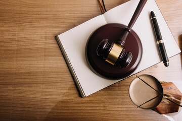 Fototapeta premium Male lawyer working with contract papers and wooden gavel on tabel in courtroom. justice and law ,attorney, court judge, concept.