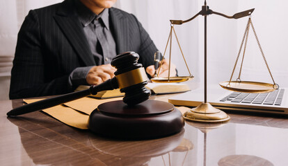 Male lawyer working with contract papers and wooden gavel on tabel in courtroom. justice and law ,attorney, court judge, concept.