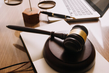Male lawyer working with contract papers and wooden gavel on tabel in courtroom. justice and law ,attorney, court judge, concept.