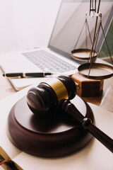 Male lawyer working with contract papers and wooden gavel on tabel in courtroom. justice and law ,attorney, court judge, concept.