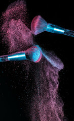 Make up brushes colliding and exploding with powder