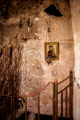 The wall of the cave monastery with an icon and a lamp
