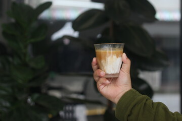 dirty coffee iced latte freeze milk pour espresso shot in a cup of coffee on scale measurement wooden bar table cafe in thailand asia by barista workout