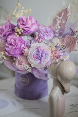 A mix of pink peonies with purple and pink roses on coffee table. Bouquet of tenders peonies a girl for mother's day, valentine's day, Woman's day 8 march.