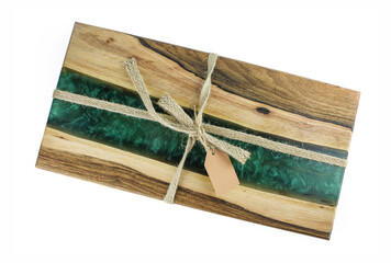 Oak wood and epoxy resin serving board with decorative rope and paper tag isolated on white...