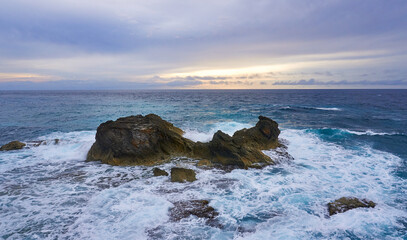rocks in the sea of punta sur isla mujeres during sunrise at golden hour, mayan riviera island in...