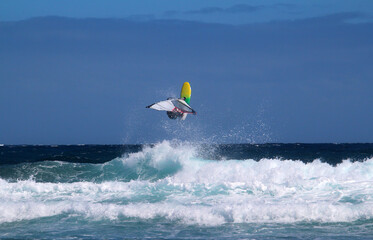 Windsurfing at the Atlantic ocean, jumping over the waves (Tenerife island, Spain)