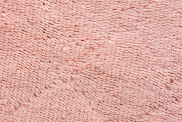 Macro of soft textile, Close up of short pile pink carpet woven, Fluffy fiber fabric cloth feels warm and comfortable.