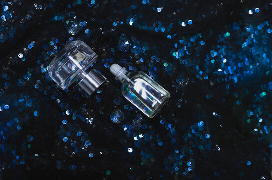 luxury gift for a woman. Essential aromatherapy. Perfume bottles on dark fancy background with glitters. Eau de toilette  transparent elegant glass.