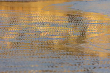 Reflection of the sunset on the coast of the sea