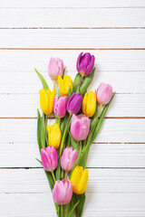 bouquet of tulips on white wooden background