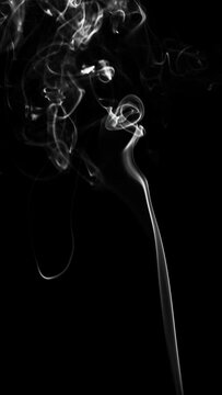 white smoke or dust, wavy and swirly on black background. perfect for compositing eg. hot tea, cigarettes or other smoking things. vertical video