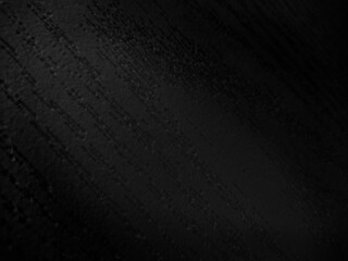 Black background with wooden pattern texture in the dark. Selective focus