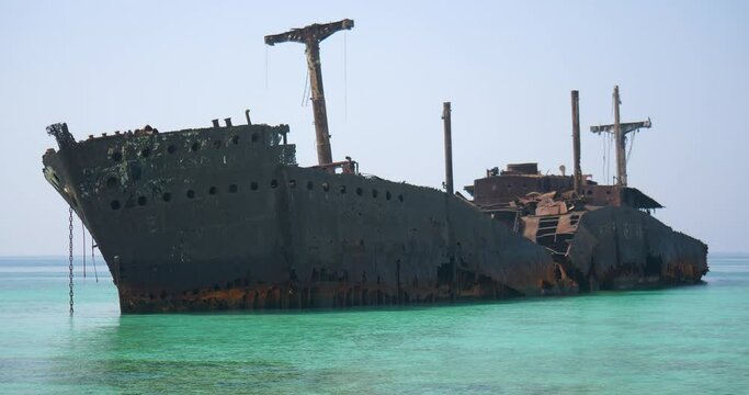 ship wreck stranded near shore - old sunken ship stuck in coral reef 2  famous Greek ship wreck in Kish Island Iran , An old abandoned shipwreck in clear blue waters 