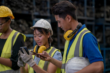 Engineers or technicians are inspecting auto parts in warehouses and factories. Factory technician using mobile phone.