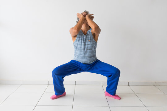 Man doing a Reusi Dat Ton (Traditional Thai Yoga) pose aimed at stretching the neck muscles
