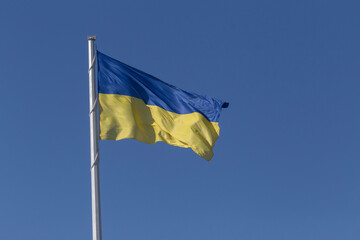 Ukrainian state flag on flagpole in Mykolaiv