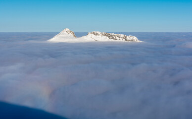 The summit of Giewont, emerging above the clouds, looks like an island in the ocean.