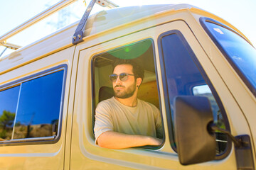 Portrait of young bearded trucker in his truck vehicle house