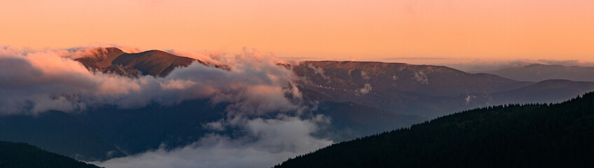 Fototapety  Petros Mountain in the morning fog, overcast mountain range at dawn, the magical mountains of Ukraine.
