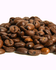 Coffee beans lie on a white background. Isolate. Macro photography. Close-up.