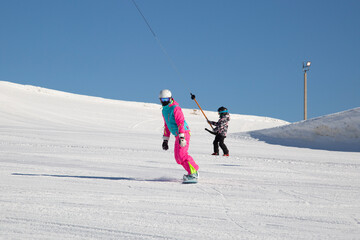 Snowboarder and Snowboard. A snowboarder goes snowboarding downhill in winter.