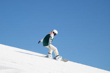 Snowboarder and Snowboard. A snowboarder goes snowboarding downhill in winter.