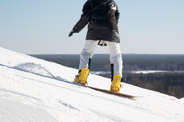 Snowboarder and Snowboard. A snowboarder goes snowboarding downhill in winter.