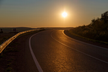 Asphalt highway in the rays of the sun
