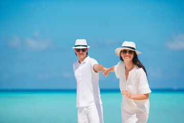 Young couple on white beach during summer vacation.