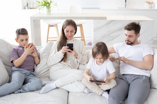 Family with kids holding smart phone