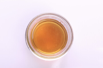 Top view of cooking oil in glass bowl isolated on white.