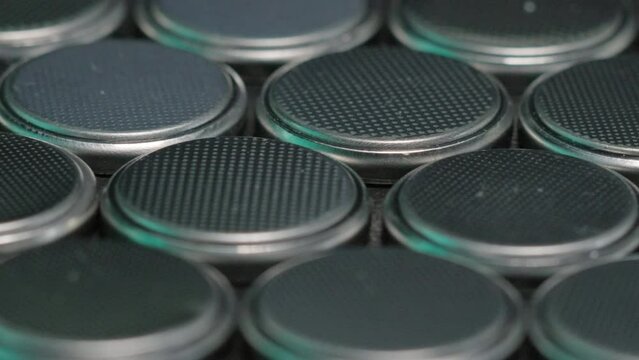 CR2032 coin cell batteries background closeup pan slide