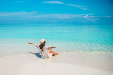 Young fashion woman in green dress on the beach