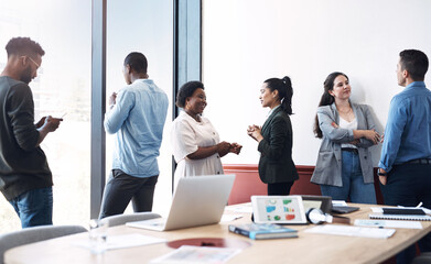 Success in the making. Shot of a group of businesspeople working in an office.