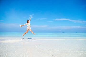 Young fashion woman in dress on the beach © travnikovstudio