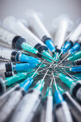 Medicine. A bunch of different syringes over a grey background