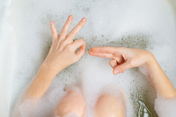Female masturbation, bathroom sex concept. Female hands in a bath with foam depict erotic gestures....