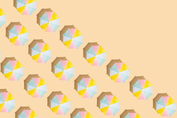 Beach umbrellas in a creative pattern inspired by summer holidays, exotic beaches. Sunbathing, leisure, relaxation.